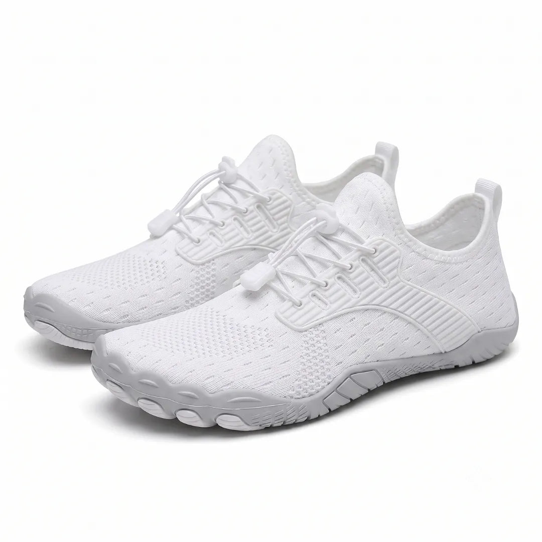 Pair of white knit barefoot sneakers shown at an angle, with gray soles and toggle laces.