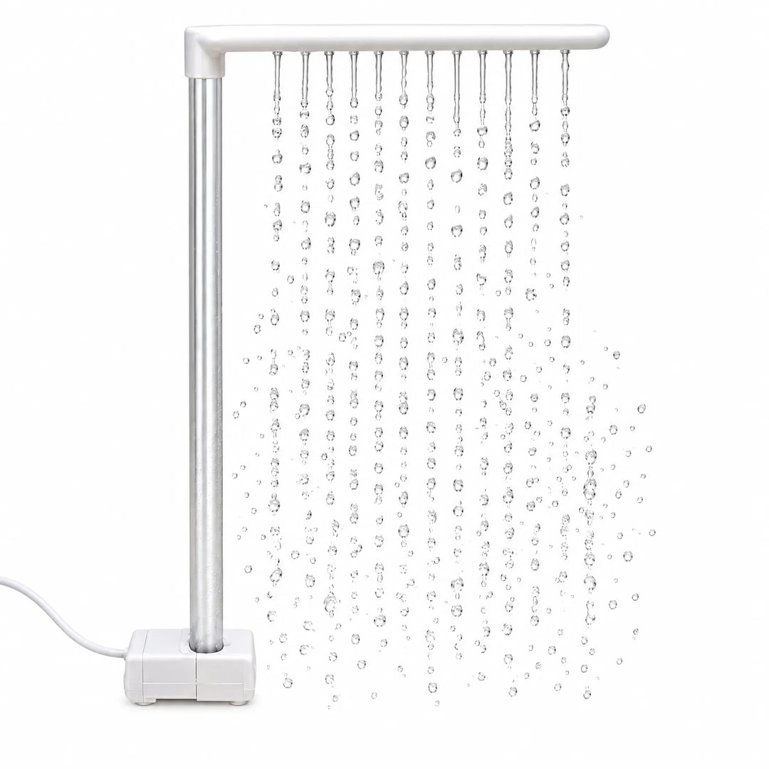 White L-shaped rain bar on a pump base with a silver upright tube, releasing rows of falling water droplets against a white background. 1