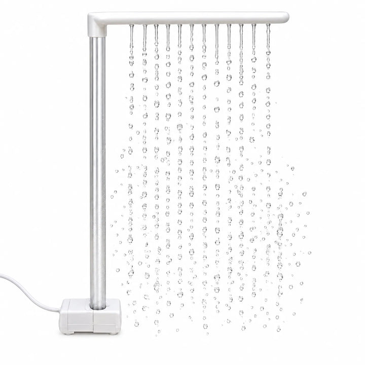 White L-shaped rain bar on a pump base with a silver upright tube, releasing rows of falling water droplets against a white background. 1