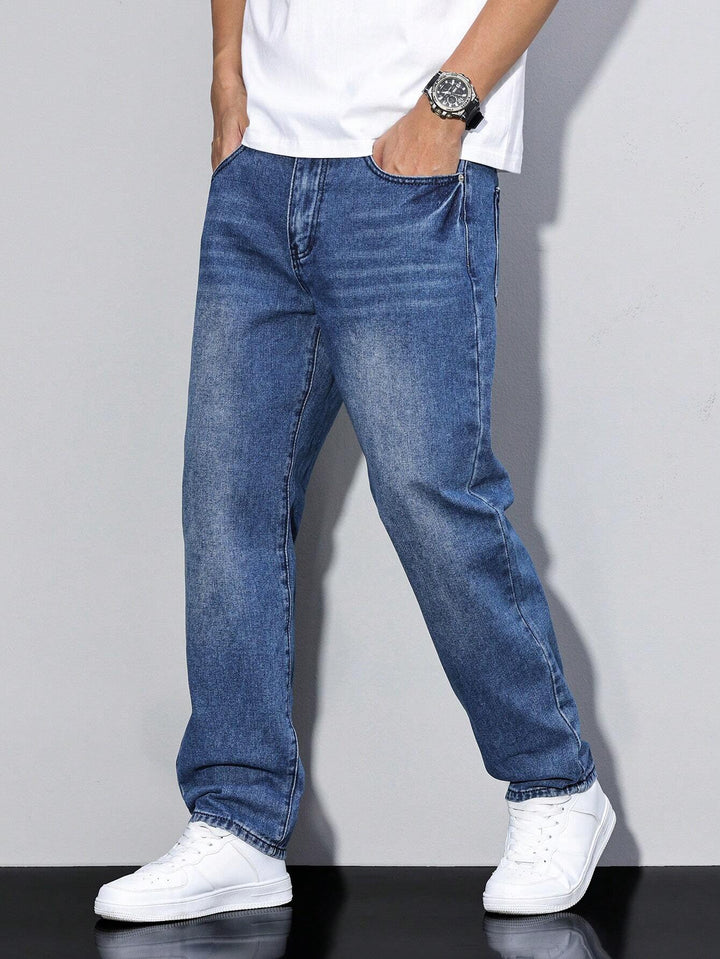 Men's baggy jeans in dark indigo-blue denim, another view on a model with both hands in the pockets.