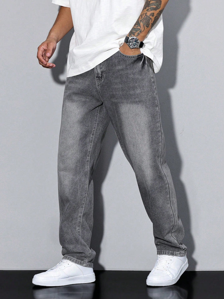 Men's baggy jeans in gray faded denim, front three-quarter view on a model with one hand in the front pocket.