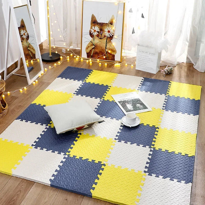 Yellow, navy and cream foam puzzle tiles forming a bright checkerboard floor.