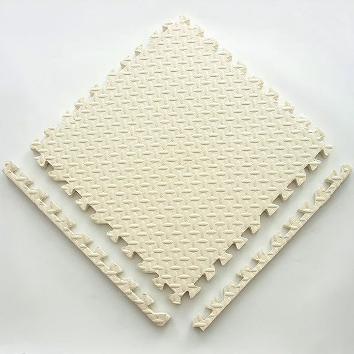 Single cream foam puzzle tile with a textured surface and two detached edge strips.