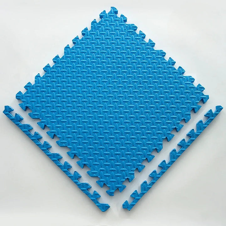 Single bright blue foam puzzle tile with an embossed leaf pattern and two loose edge strips.