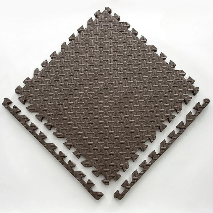 Single dark brown foam puzzle tile with an embossed leaf pattern and two separate edge strips.