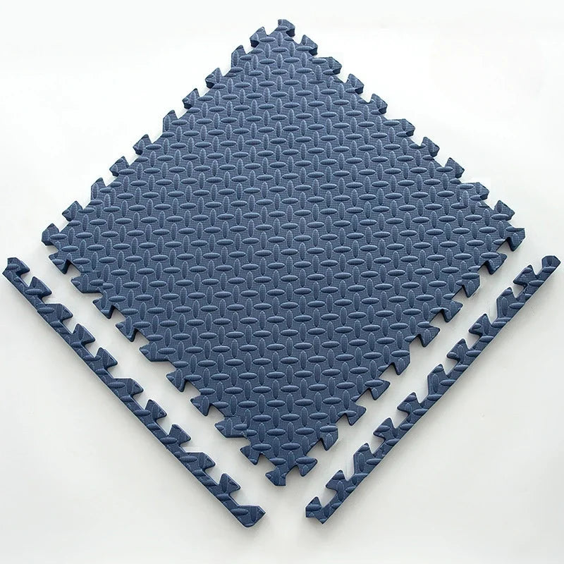 Single navy blue foam puzzle tile with an embossed leaf pattern and two loose edge strips.