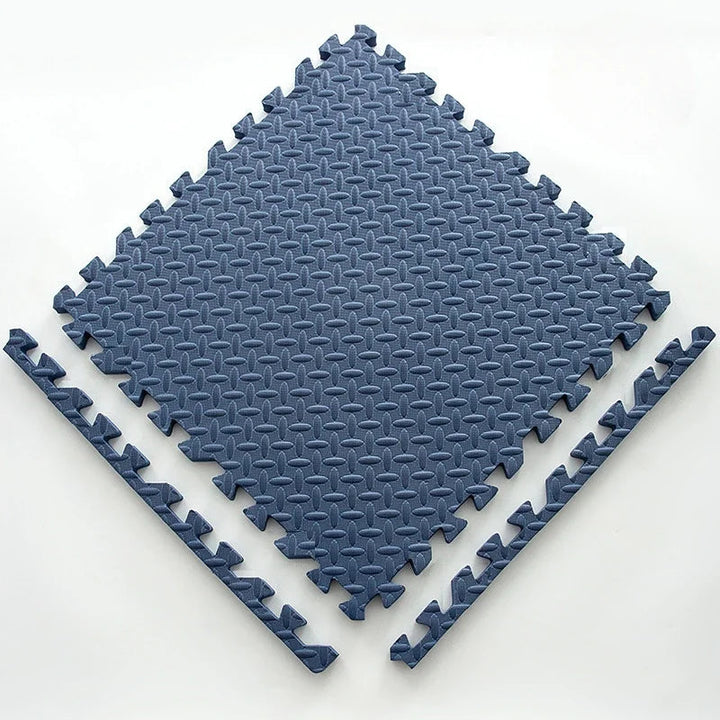 Single navy blue foam puzzle tile with an embossed leaf pattern and two loose edge strips.