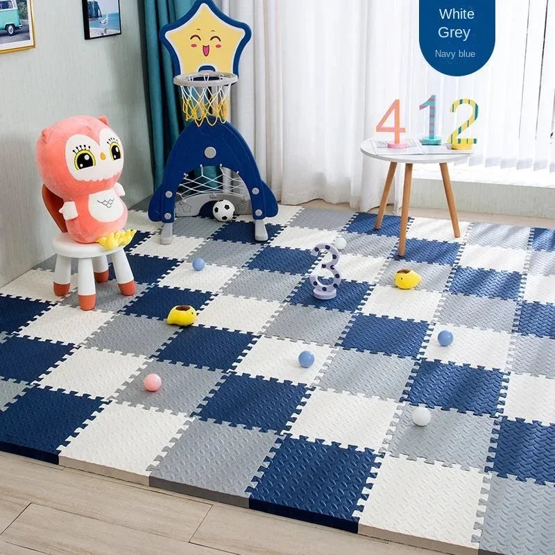 Navy, gray and white foam tile floor in a kids' play corner.