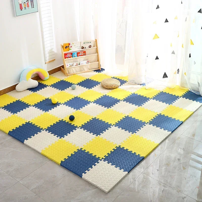 Yellow, navy and cream foam puzzle mat covering a floor beside a small bookshelf.