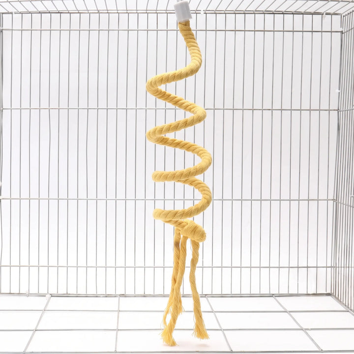 Yellow twisted cotton rope perch coiled in a spiral, hanging inside an empty wire cage with frayed tassels at the bottom. 1