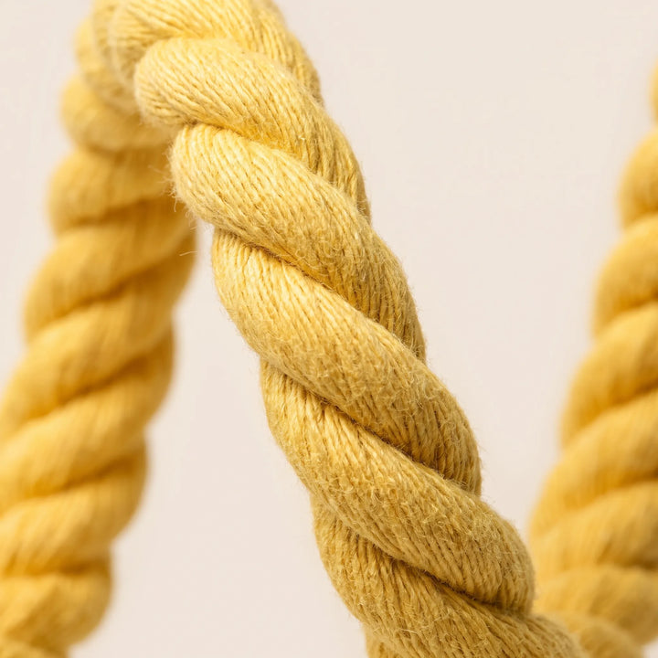 Close-up of the twisted yellow cotton rope strands, showing the soft fibers and thick braided texture. 3