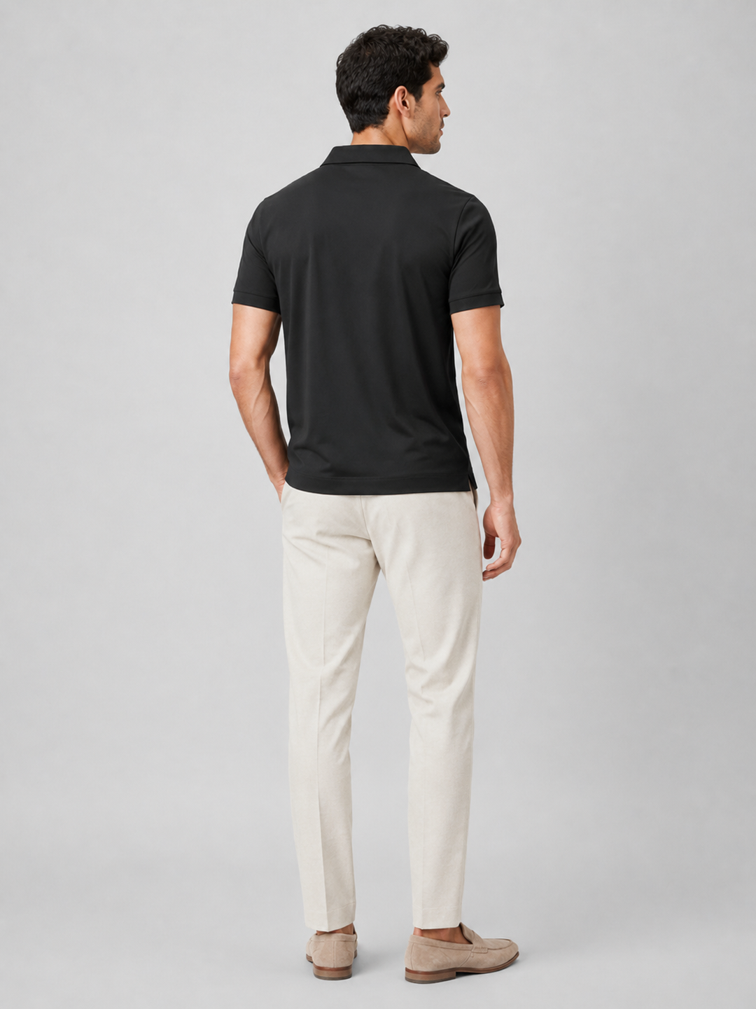 Black silky touch polo shirt back view on a model.