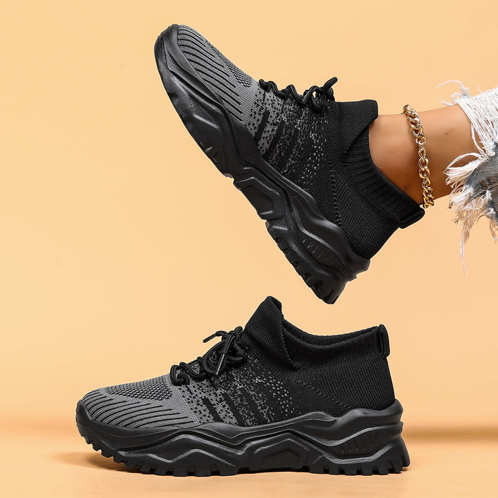Black and gray gradient knit sneakers, side view with the chunky sole visible.