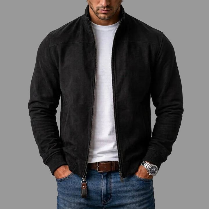 Black suede bomber worn open by a model over a white tee and jeans, with a leather zipper pull. 1