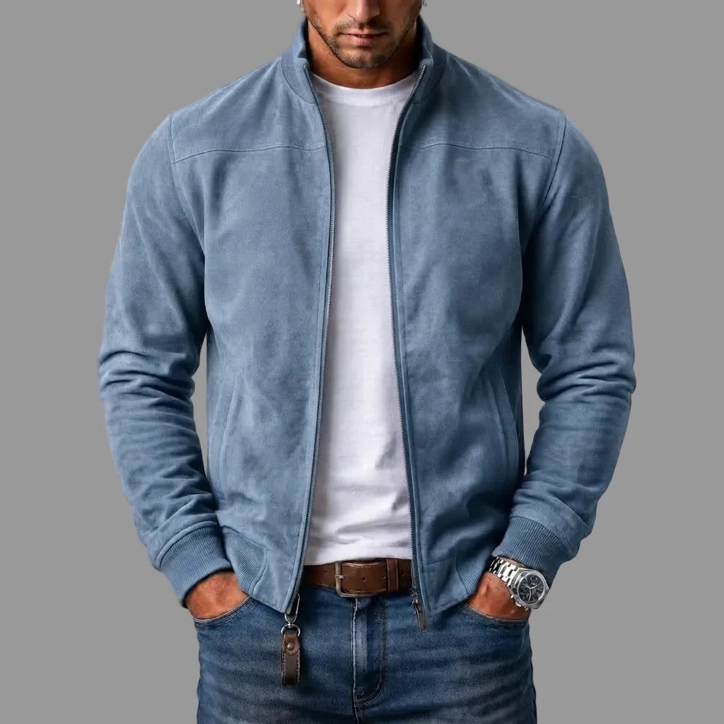 Light blue suede bomber worn open by a model over a white tee and jeans, with a leather zipper tab. 4