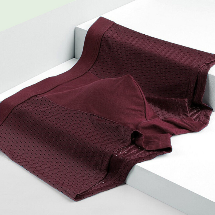 Burgundy mesh boxer brief laid flat on white steps, showing the waistband, solid front panel and breathable perforated sides 6