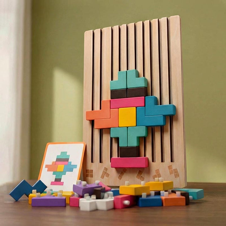 Upright wooden board with a symmetrical colorful pattern, a task card and a pile of pegged blocks on a table before a green wall. 16