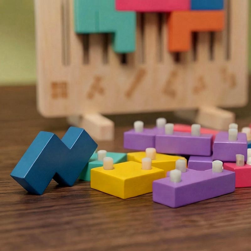 Wooden Tetris puzzle game detail of loose blocks with small white pegs