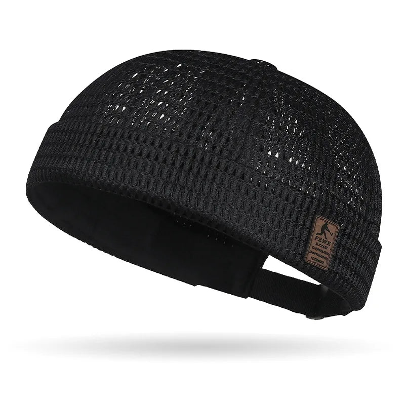 Black open weave brimless cap seen from the side, showing the cuff, small patch and strap 18