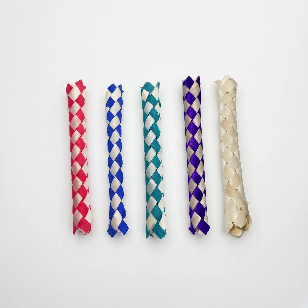 Five woven finger traps laid side by side on a white background in red, blue, teal, purple and plain natural straw. 1