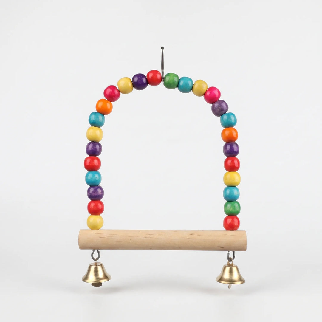 Straight-on view of the empty beaded swing with a smooth natural wood perch, two brass-colored bells and a top hanging clip on a plain background. 5
