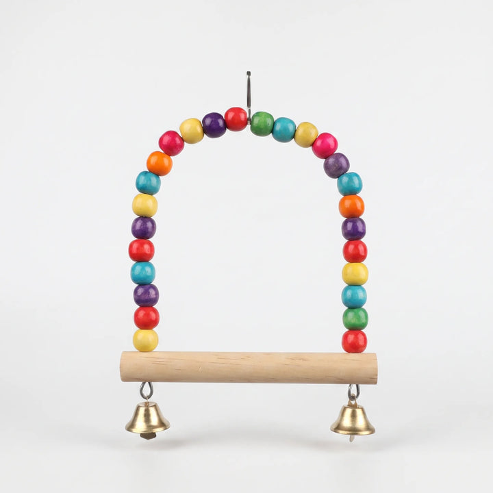 Straight-on view of the empty beaded swing with a smooth natural wood perch, two brass-colored bells and a top hanging clip on a plain background. 5