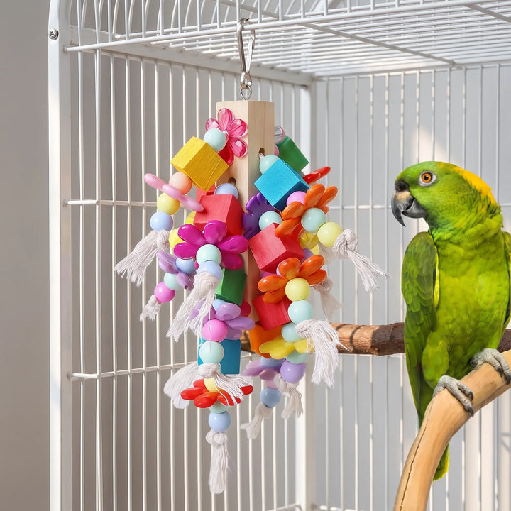 The same chew toy hanging inside a white cage while a green parrot with a yellow nape perches beside it. 2