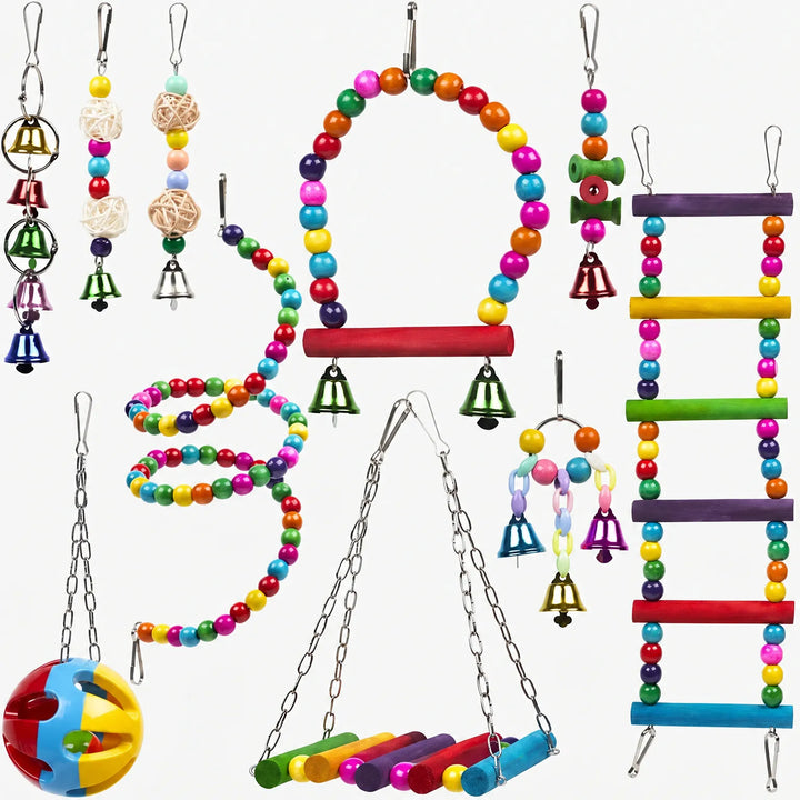 Flat lay of ten hanging bird toys on white: bead swing, spiral, ladder, rattan balls, bell strings and a perforated ball. 1