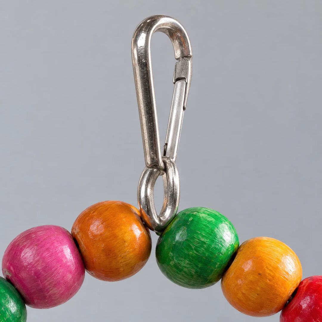 Close-up of the metal snap hook attached to the top of the bead swing between orange and green wooden beads. 4