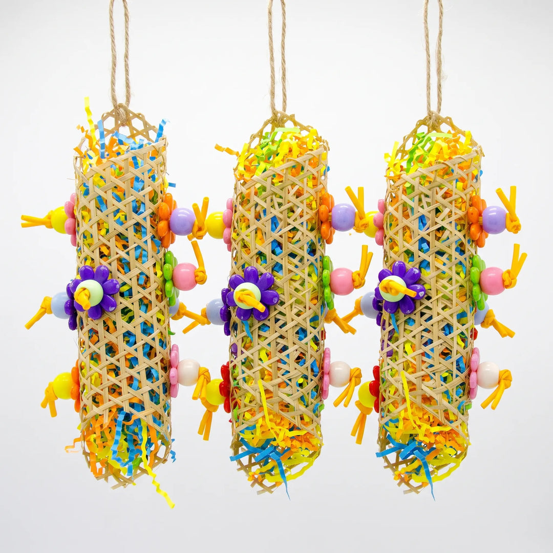 Three hanging woven cane tubes stuffed with colorful shredded paper, decorated with flower-shaped and round beads on jute loops. 3