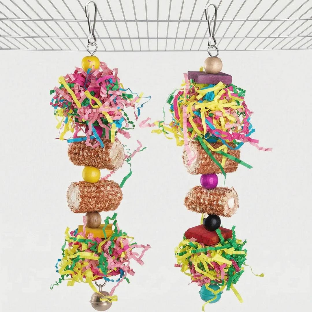 Two hanging foraging toys stacking shredded paper, corn-husk rolls, wooden beads and blocks, each ending in a small bell. 5