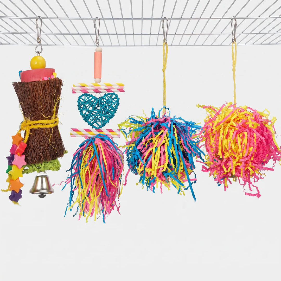 Four different hanging toys side by side: the star-bead fiber toy, a rattan heart with paper straws, and two shredded paper balls. 7