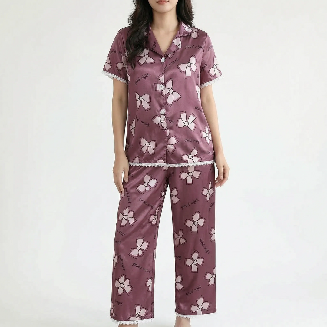 Model wearing a plum-colored satin version with light pink bow prints, lace trim along the sleeves, top hem and pant cuffs. 13