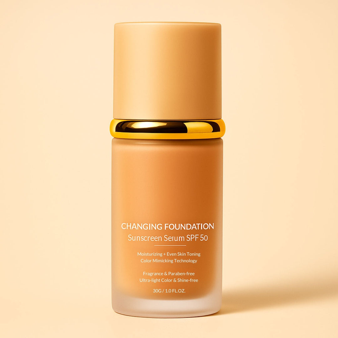 Front view of a frosted glass foundation bottle with a tan cap and gold collar.