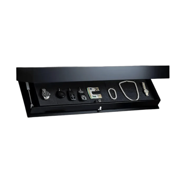 Black floating shelf with its hidden compartment tilted open, showing a watch, car keys, cash, pearl jewelry and a wristwatch on dark foam. 1