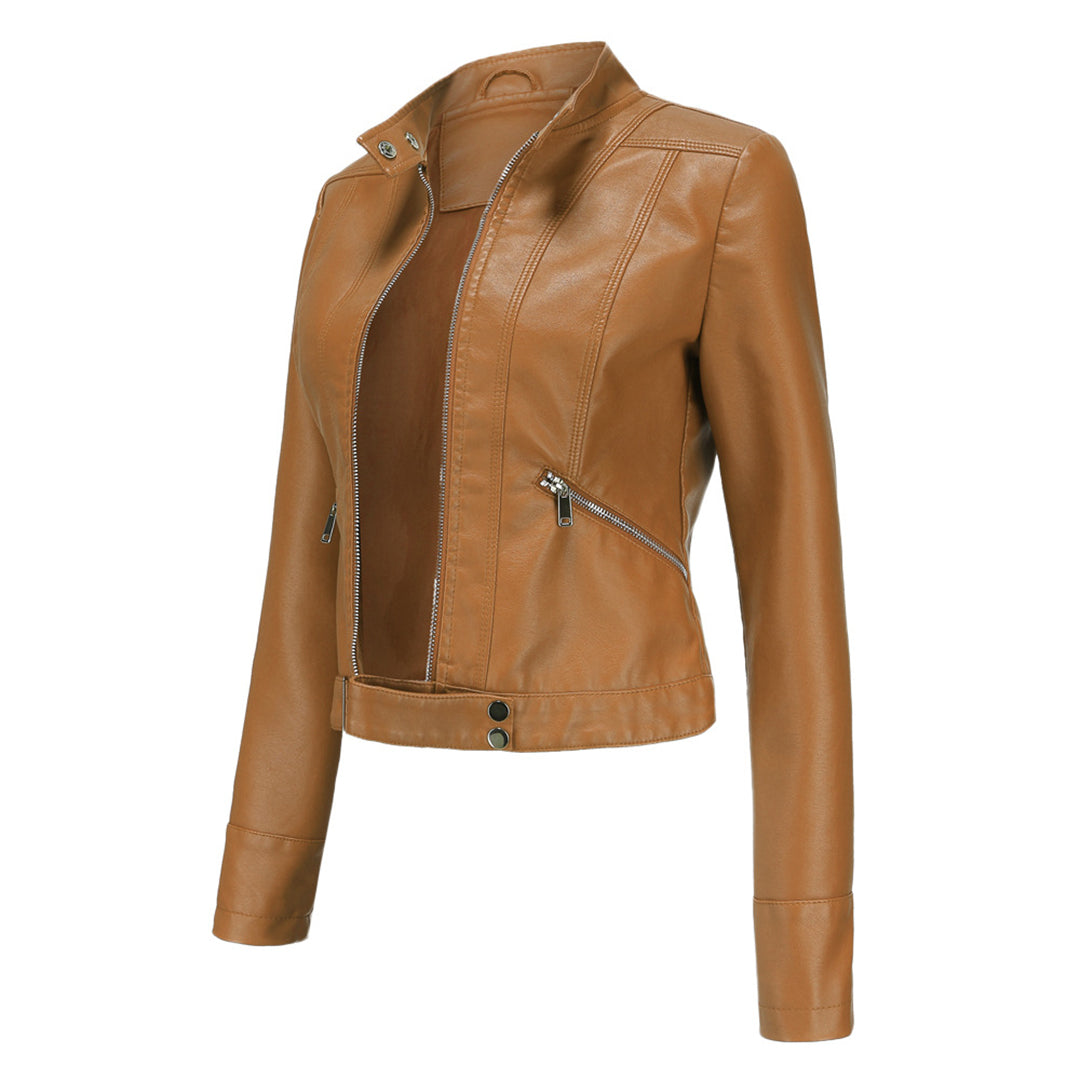 Tan camel-colored cropped jacket in three-quarter view, open at the front, showing zippered pocket and snap waist tab. 12