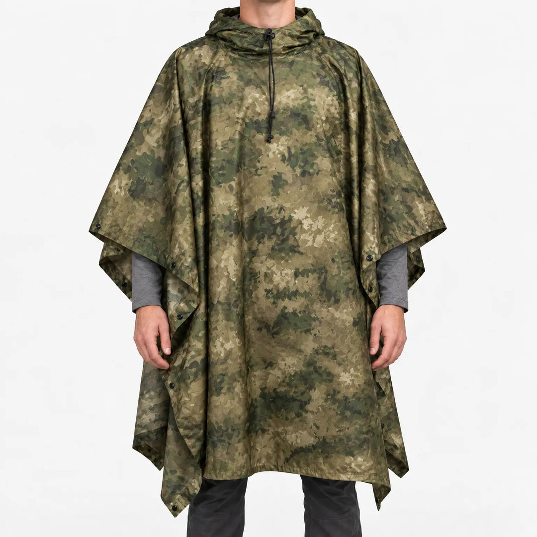 Front view of a hooded poncho in mottled olive green and tan camouflage, worn over a gray long-sleeve shirt. 10