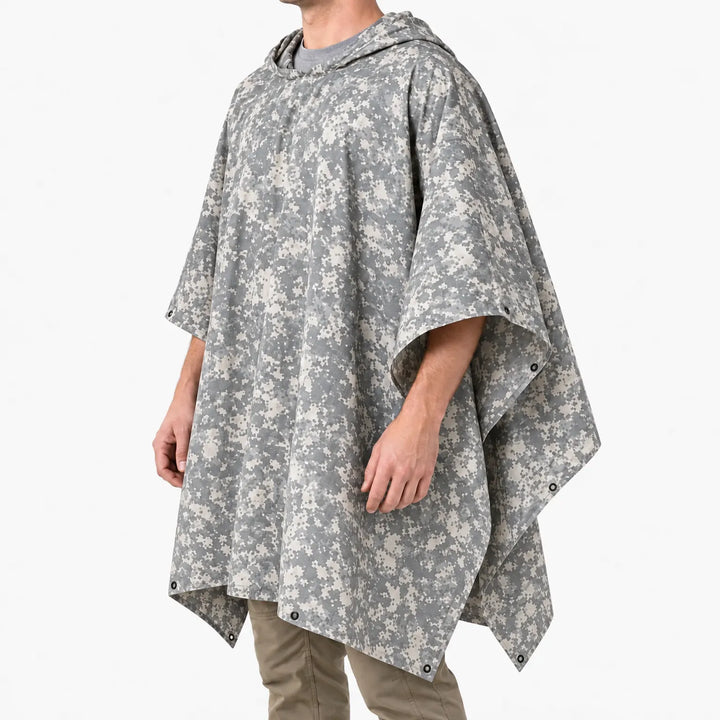 Three-quarter side view of a man in a hooded poncho with light gray digital camouflage, showing grommets at the corners. 5