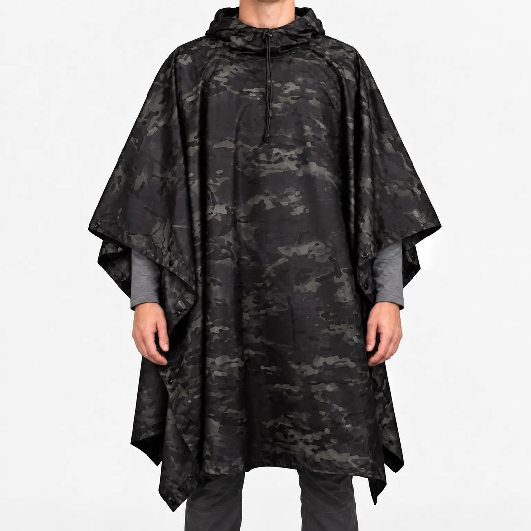 Front view of a hooded poncho in black and dark gray camouflage with a drawcord at the neck and snaps at the sides. 8