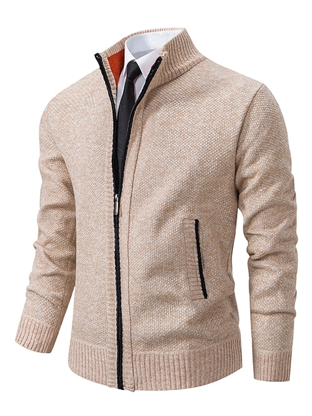 Beige knit zip-up cardigan with stand collar and side pockets, shown over a white shirt and black tie.