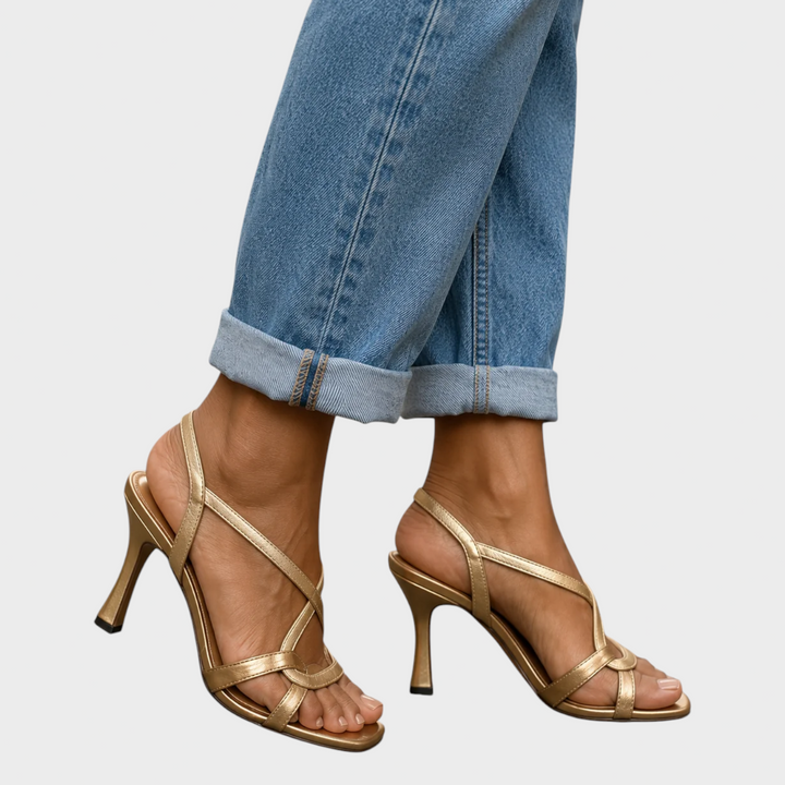 Gold crisscross-strap sandals with flared stiletto heels and ankle slingbacks, another view. 2