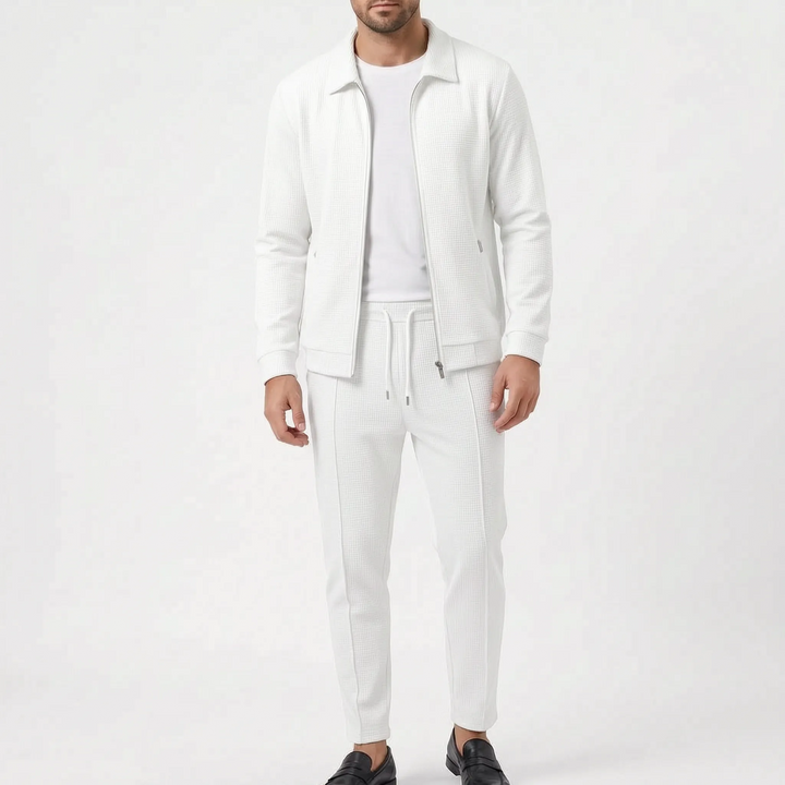 Model wearing the set in white, with zip jacket open over a white tee and drawstring pants with a center pintuck. 6