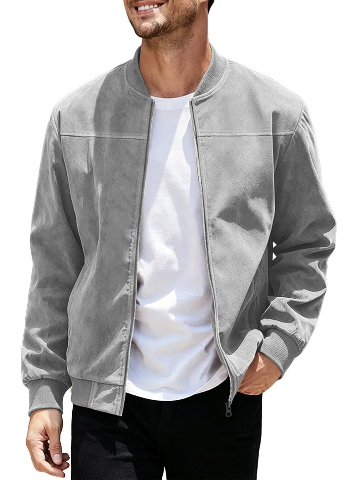 Man wearing the light gray zip-up jacket open over a white tee, hand in pocket 43