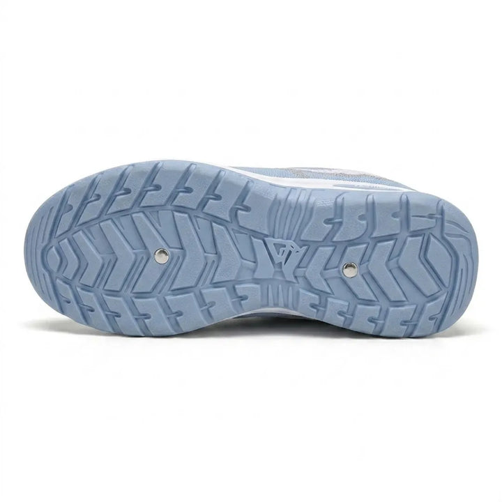 Bottom view of the light blue outsole showing a deep chevron tread pattern with two small metal studs. 9