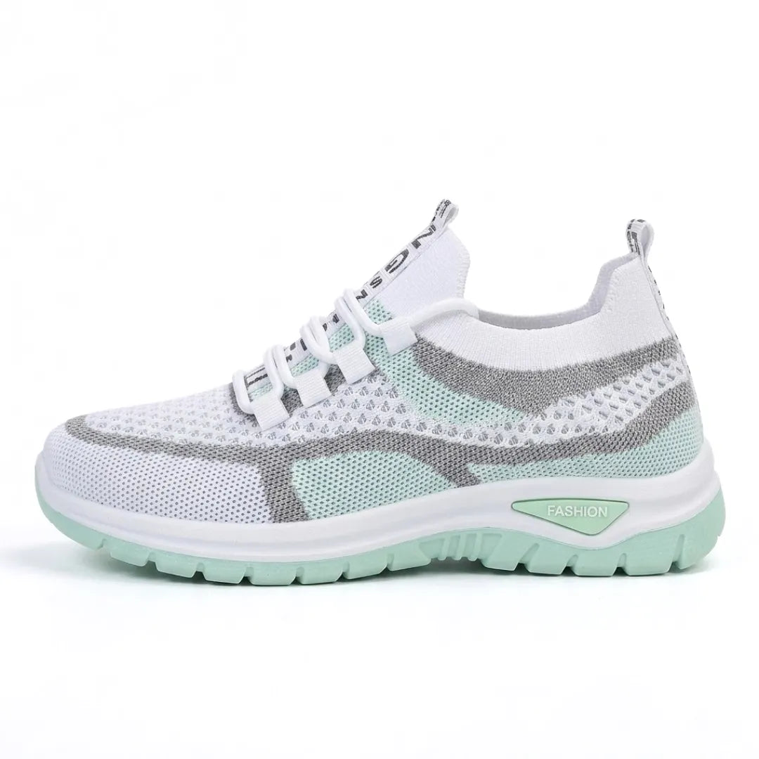 White mesh knit sneaker with mint green panels, gray accents, a thick white midsole and mint outsole.