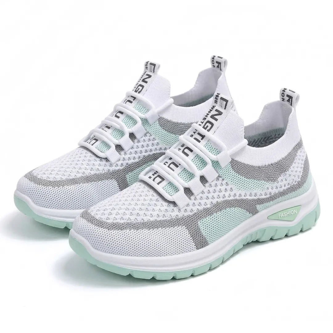 Pair of white and mint green mesh sneakers with white lace loops, gray trim and a mint outsole.