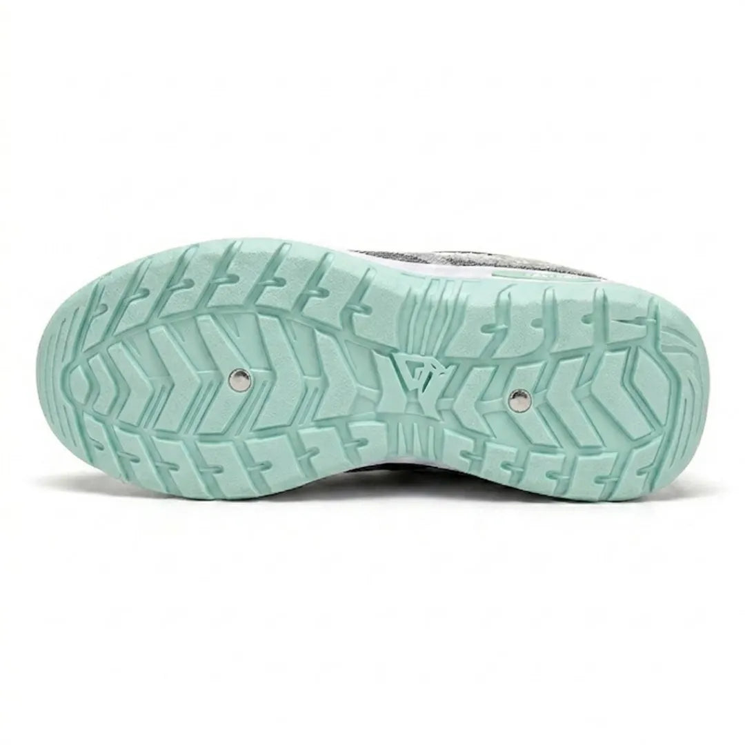 Bottom view of the mint green outsole showing a deep chevron tread pattern with two small metal studs. 18