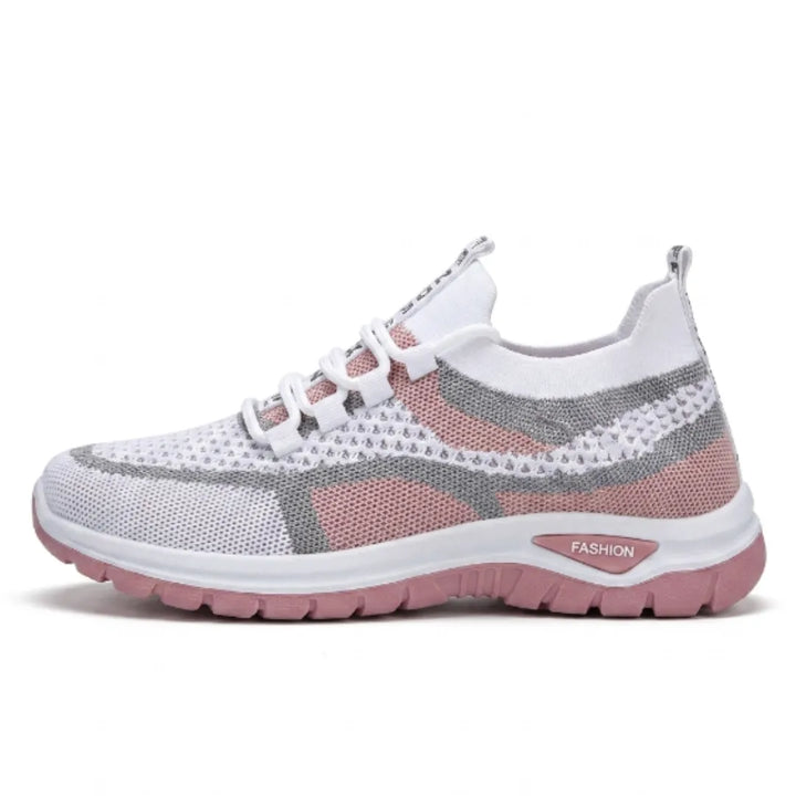 White mesh knit sneaker with dusty pink panels, gray accents, a thick white midsole and pink outsole.