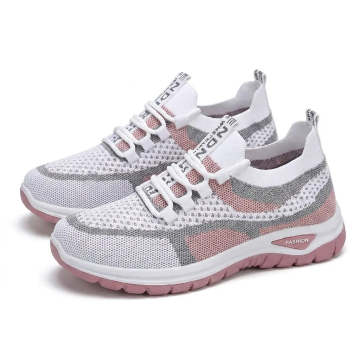 Pair of white knit mesh sneakers with gray and pink panels, bungee-style laces, heel pull tabs and thick pink soles, shown at an angle. 25