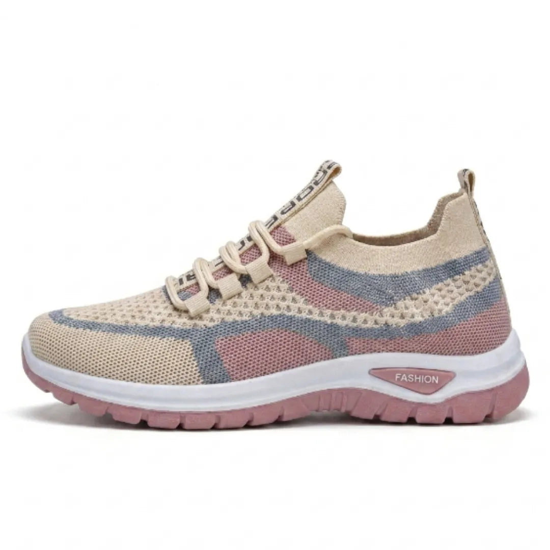 Side view of a beige knit mesh sneaker with pink and gray stripes, elastic laces, white midsole and pink treaded sole. 28